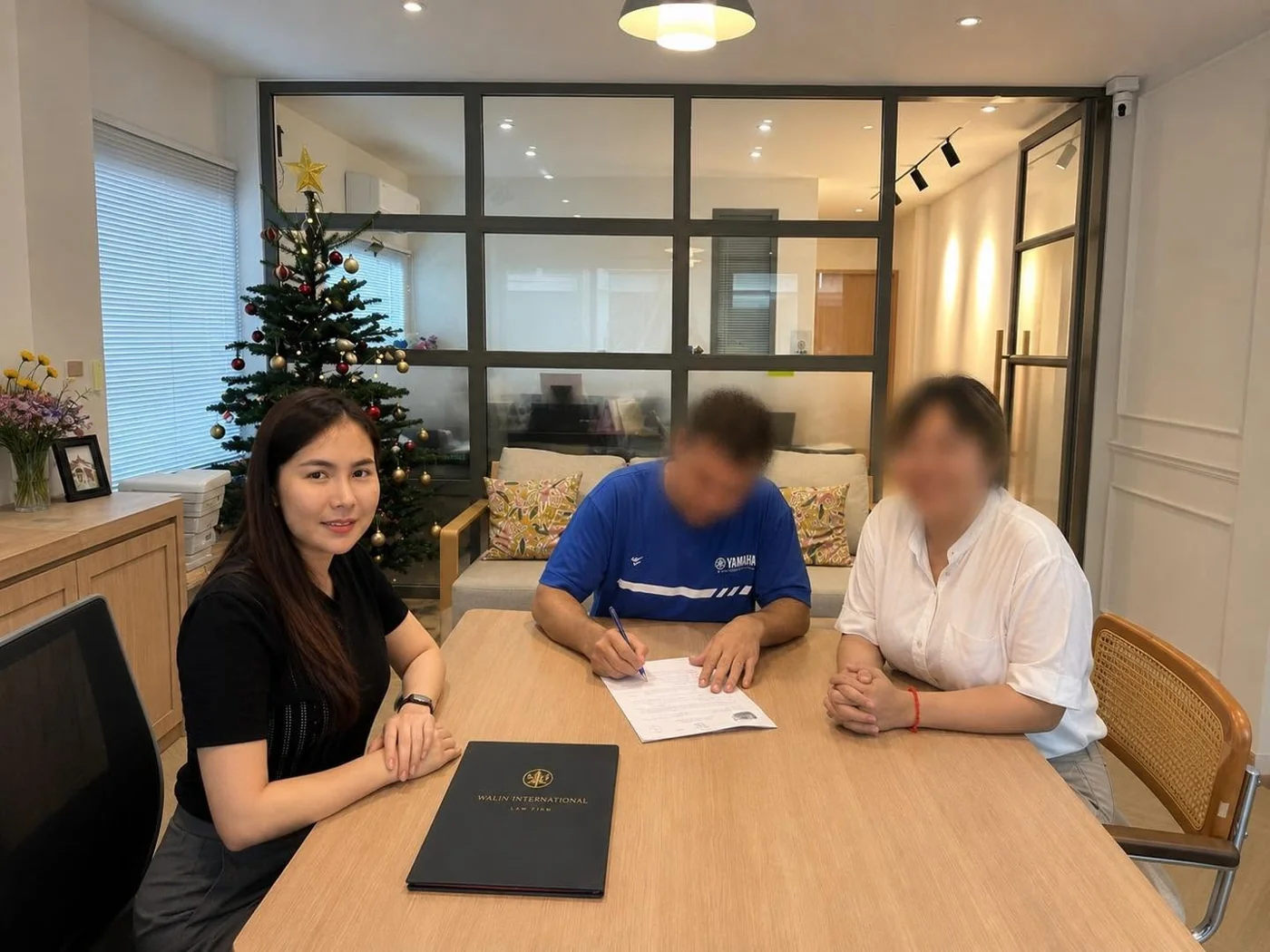 Walin at her office during a document signing, with client faces obscured
